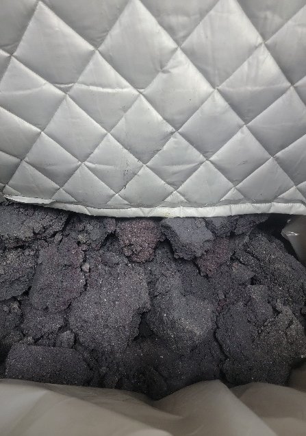 Dried paint solids in a collection bag