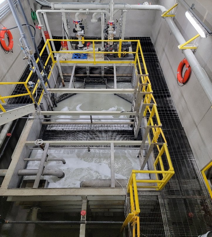 Paint booth sludge pit, with the recirculating booth water below the service grating
