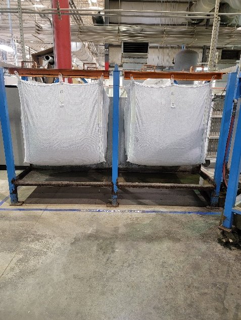 Dewatering bags collecting paint solids under a Palin unit